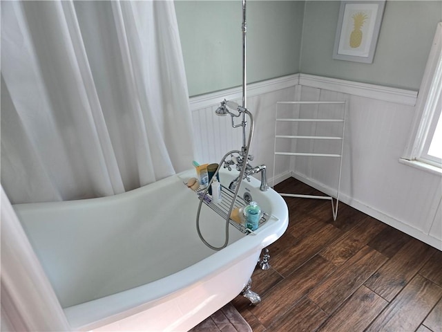 bathroom featuring hardwood / wood-style flooring and a bathing tub