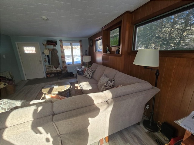 living room featuring hardwood / wood-style floors and wooden walls