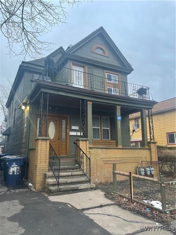 view of front of property with a porch and a balcony