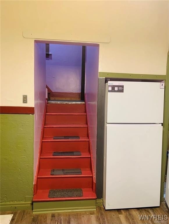 stairs featuring hardwood / wood-style flooring