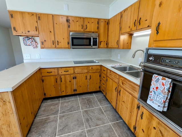 kitchen featuring black electric cooktop, sink, wall oven, and kitchen peninsula