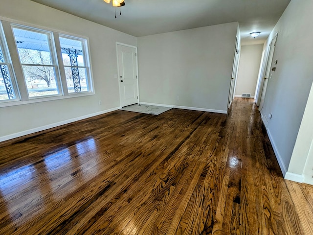 interior space featuring dark wood-type flooring and ceiling fan