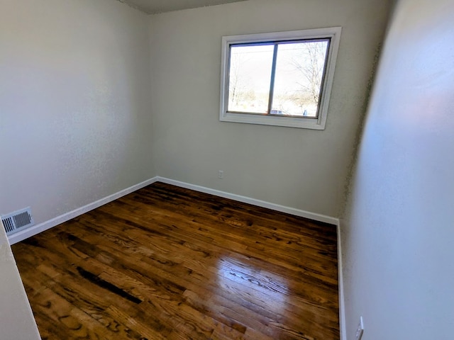 empty room featuring dark hardwood / wood-style flooring