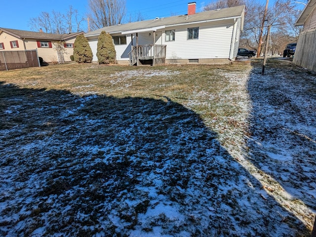 rear view of property with a lawn