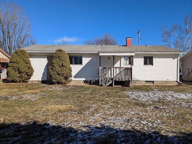 rear view of house with a yard