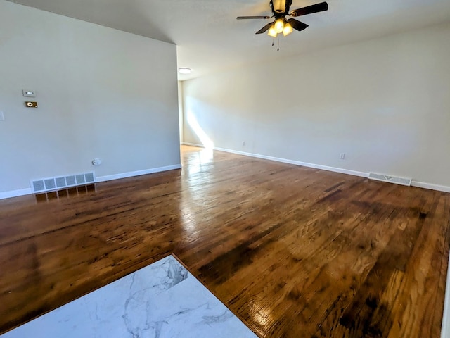 empty room featuring ceiling fan and dark hardwood / wood-style floors