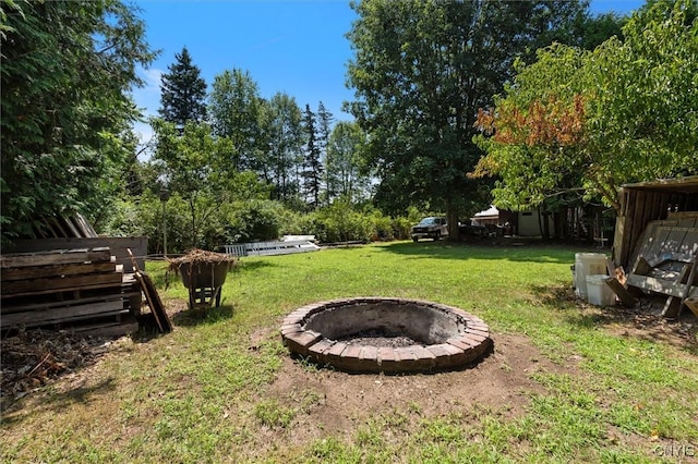 view of yard with a fire pit