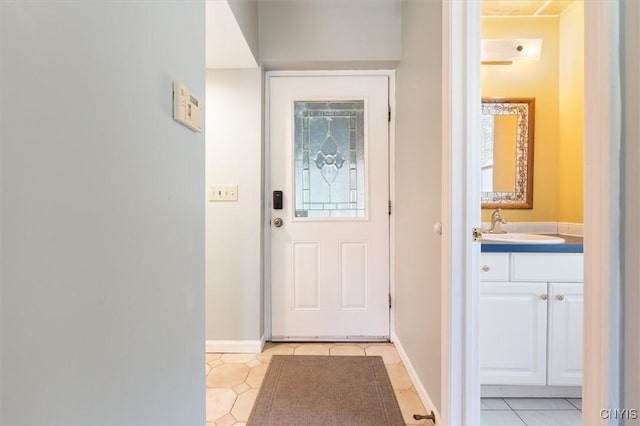 doorway featuring sink and light tile patterned floors