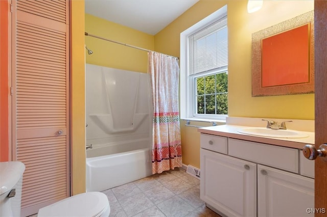 full bathroom featuring vanity, shower / bath combo with shower curtain, and toilet