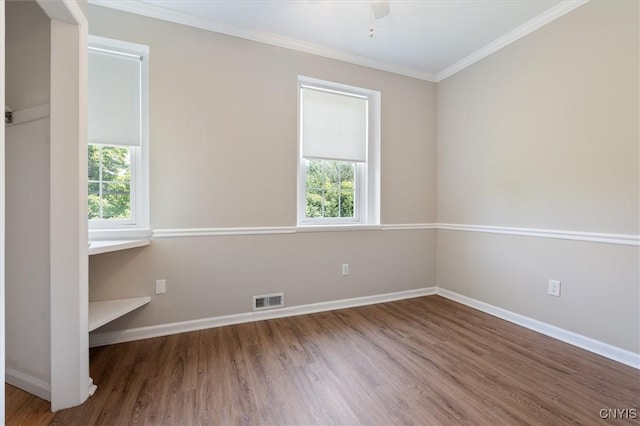 spare room featuring crown molding, wood-type flooring, and ceiling fan