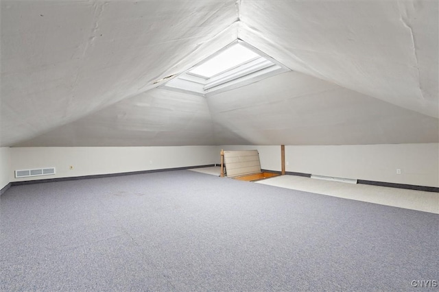 additional living space with carpet and vaulted ceiling with skylight