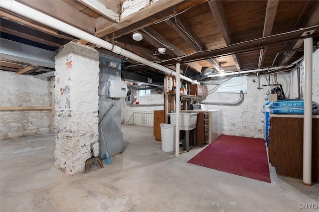 basement with separate washer and dryer, sink, and heating unit