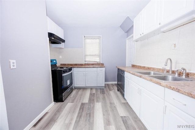 kitchen featuring tasteful backsplash, white cabinetry, sink, light hardwood / wood-style floors, and gas stove