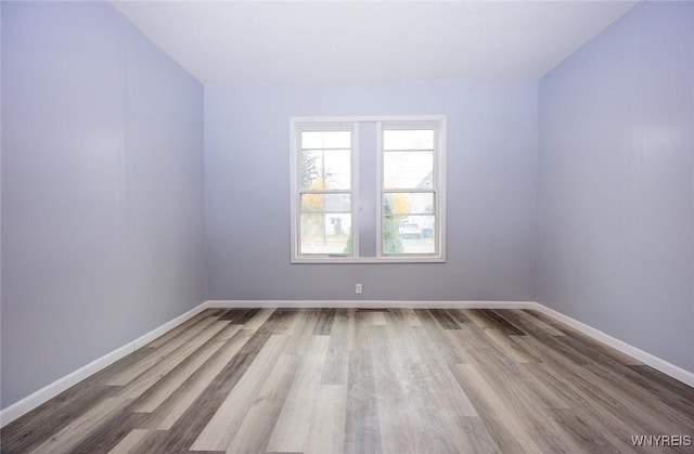 spare room with hardwood / wood-style flooring