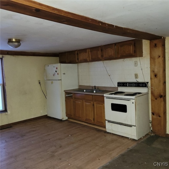 kitchen featuring dark wood-type flooring, sink, white appliances, beam ceiling, and decorative backsplash