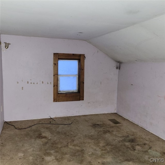 additional living space featuring lofted ceiling