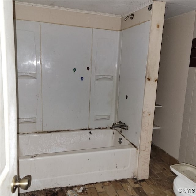 bathroom featuring shower / bathing tub combination, hardwood / wood-style floors, and toilet