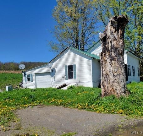 207 S Rd, Plainfield, NY 13491 - view of side of home featuring an attached garage