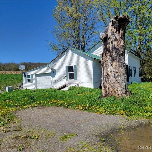 207 S Rd, Plainfield, NY 13491 - view of side of property featuring a garage