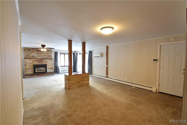 unfurnished living room featuring ceiling fan, a baseboard heating unit, a wall mounted air conditioner, carpet floors, and a fireplace