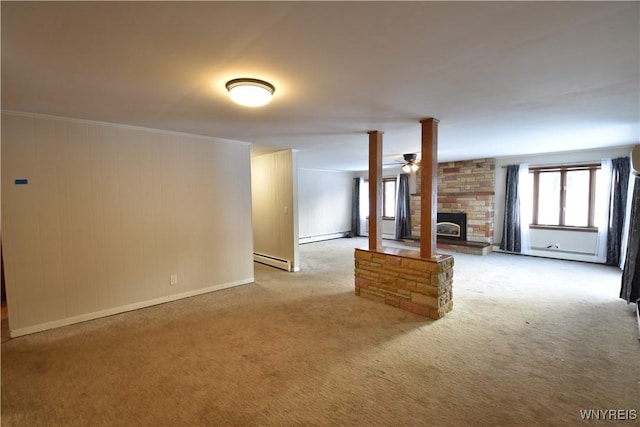 unfurnished living room with ceiling fan, ornamental molding, light colored carpet, and baseboard heating