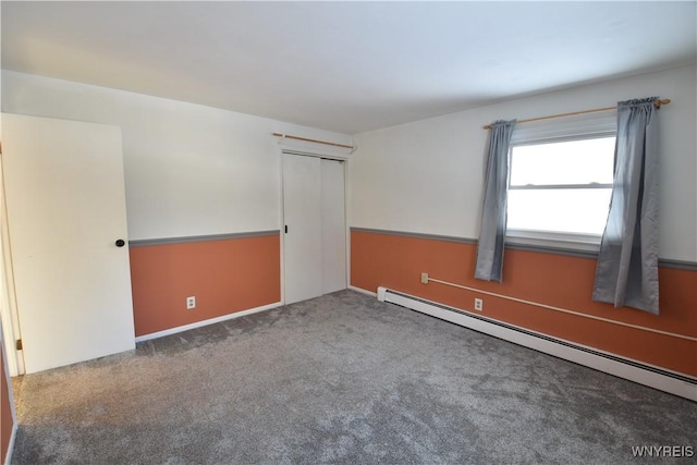 spare room featuring carpet flooring and baseboard heating