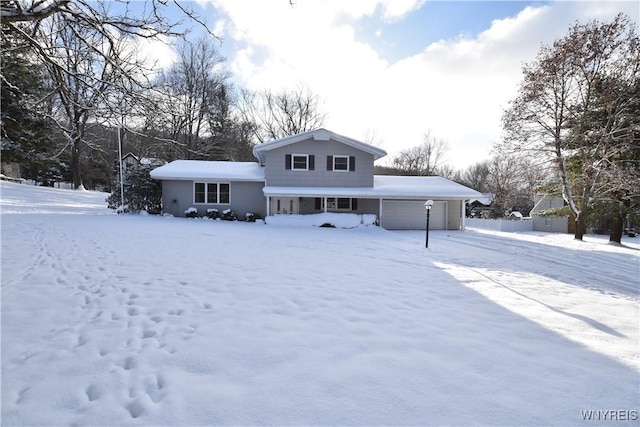 view of snow covered back of property