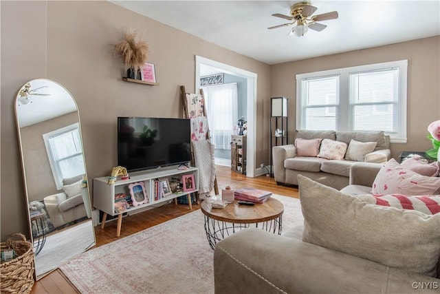 living room with wood-type flooring and ceiling fan