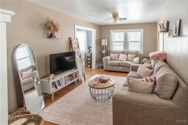 living room with hardwood / wood-style floors and ceiling fan