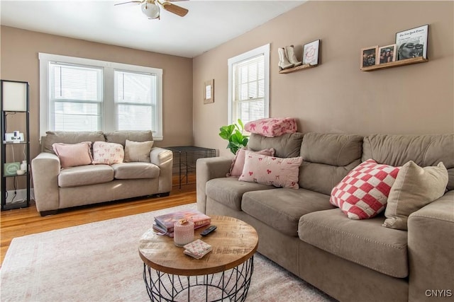 living room featuring light hardwood / wood-style flooring and ceiling fan