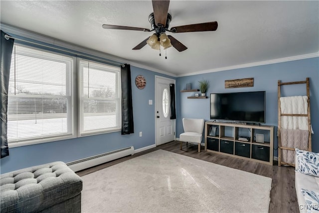 living room with hardwood / wood-style floors, a baseboard radiator, ornamental molding, and ceiling fan