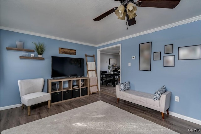 living room featuring dark wood-type flooring, ceiling fan, and ornamental molding