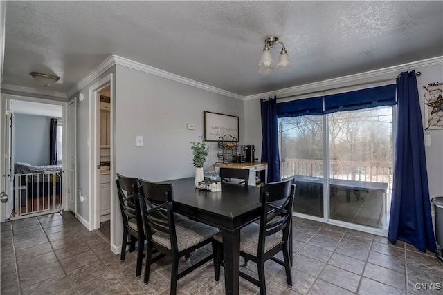 dining space featuring crown molding, tile patterned floors, and a textured ceiling