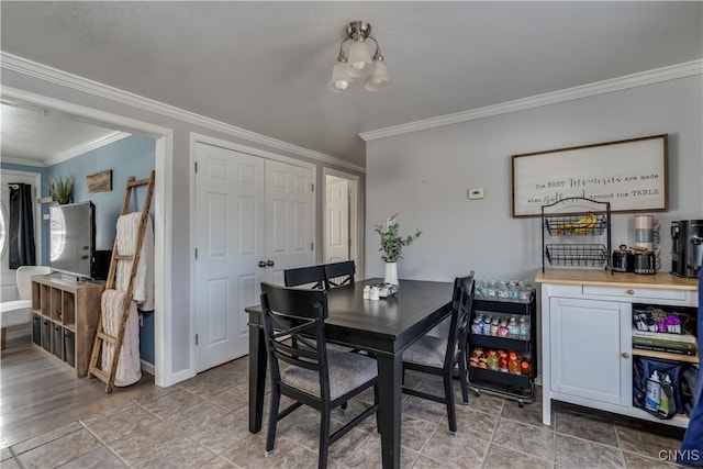 dining room featuring crown molding