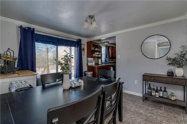 dining room featuring crown molding and sink