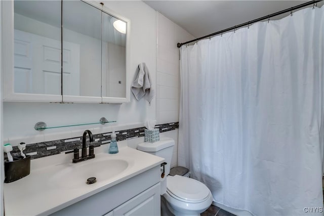 bathroom featuring walk in shower, toilet, tasteful backsplash, tile walls, and vanity