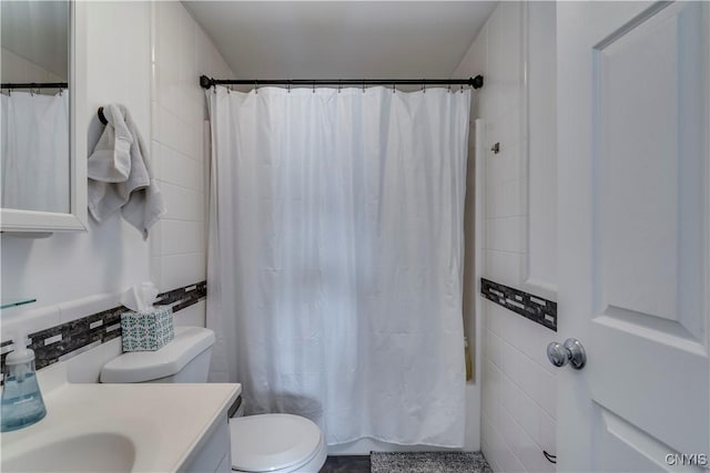 full bathroom with vanity, tile walls, shower / bath combo, and toilet