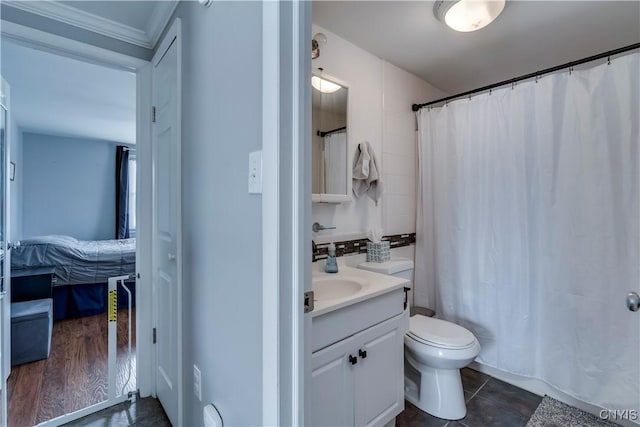 bathroom with tile patterned flooring, vanity, and toilet