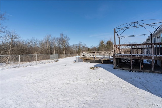 snowy yard with a deck