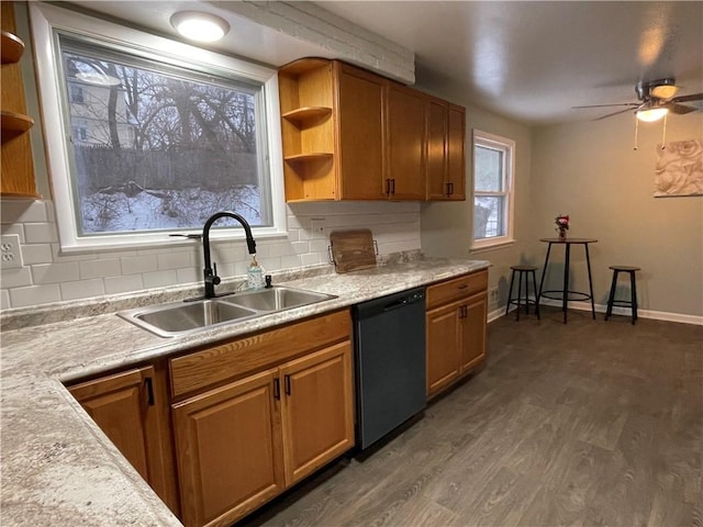 kitchen with sink, dark hardwood / wood-style floors, black dishwasher, ceiling fan, and backsplash