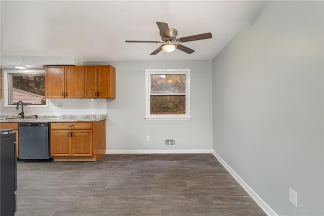 kitchen with dark hardwood / wood-style floors, sink, dishwashing machine, and backsplash