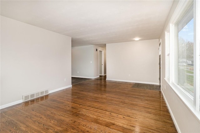 unfurnished room with dark hardwood / wood-style floors