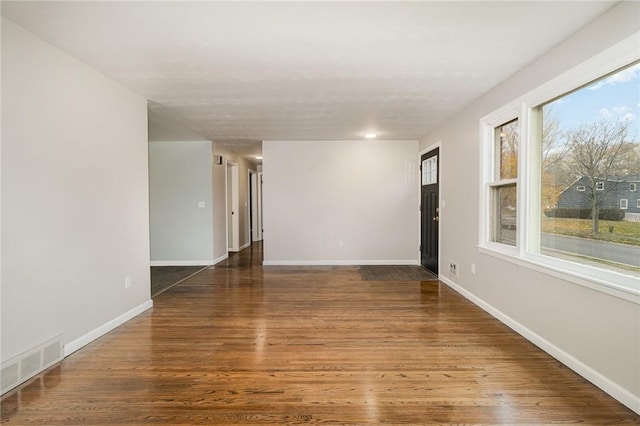 unfurnished room featuring dark hardwood / wood-style flooring