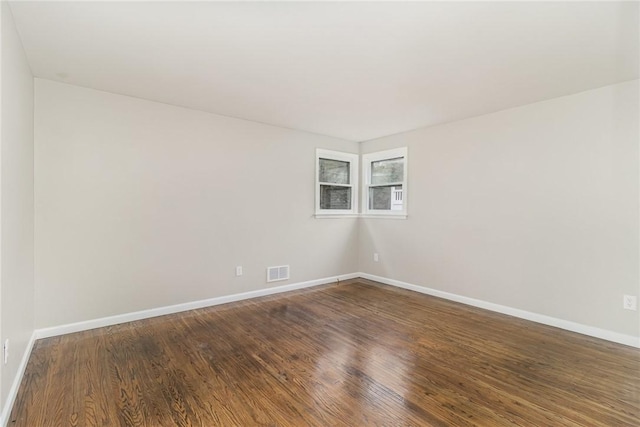 spare room featuring dark hardwood / wood-style flooring