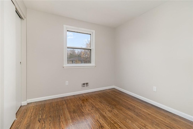 unfurnished bedroom with hardwood / wood-style flooring and a closet