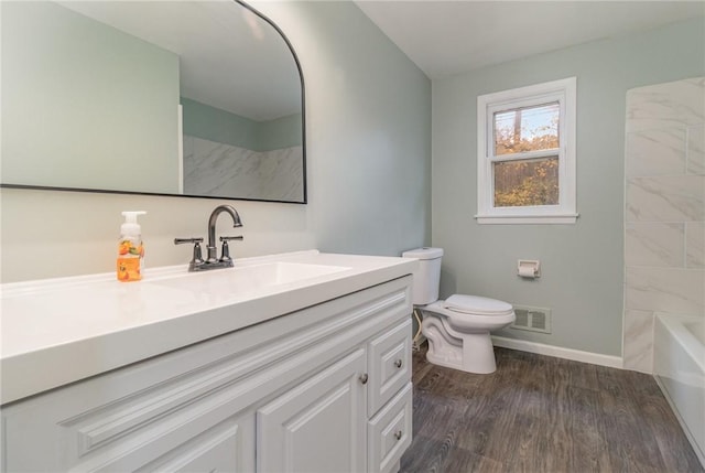 full bathroom with vanity, hardwood / wood-style flooring, tub / shower combination, and toilet