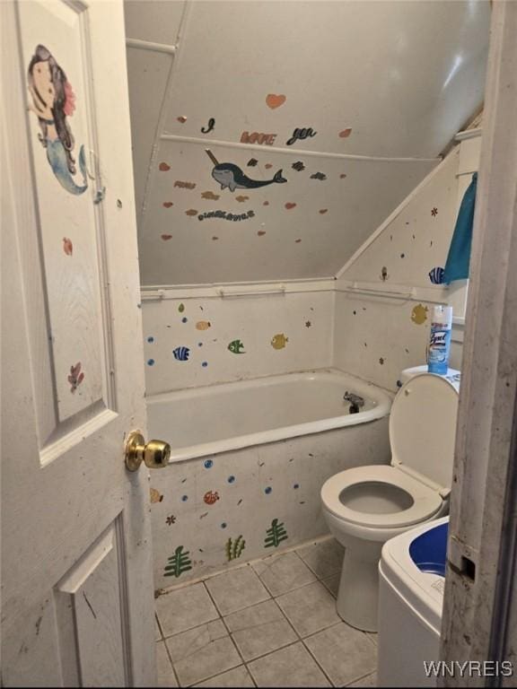 bathroom with tiled tub, tile patterned floors, and toilet