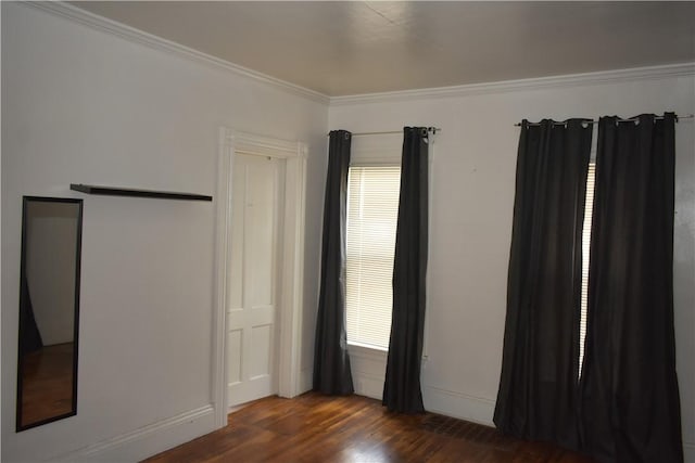 interior space featuring ornamental molding and dark wood-type flooring