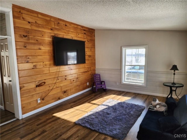 living room featuring dark hardwood / wood-style floors and a textured ceiling