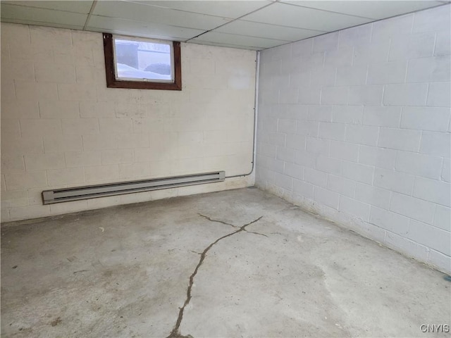 basement with a drop ceiling and baseboard heating